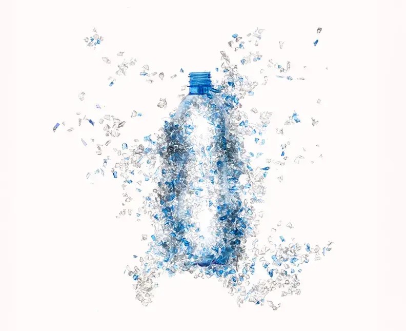 Plastic bottle formed from blue and clear recycled plastic fragments
